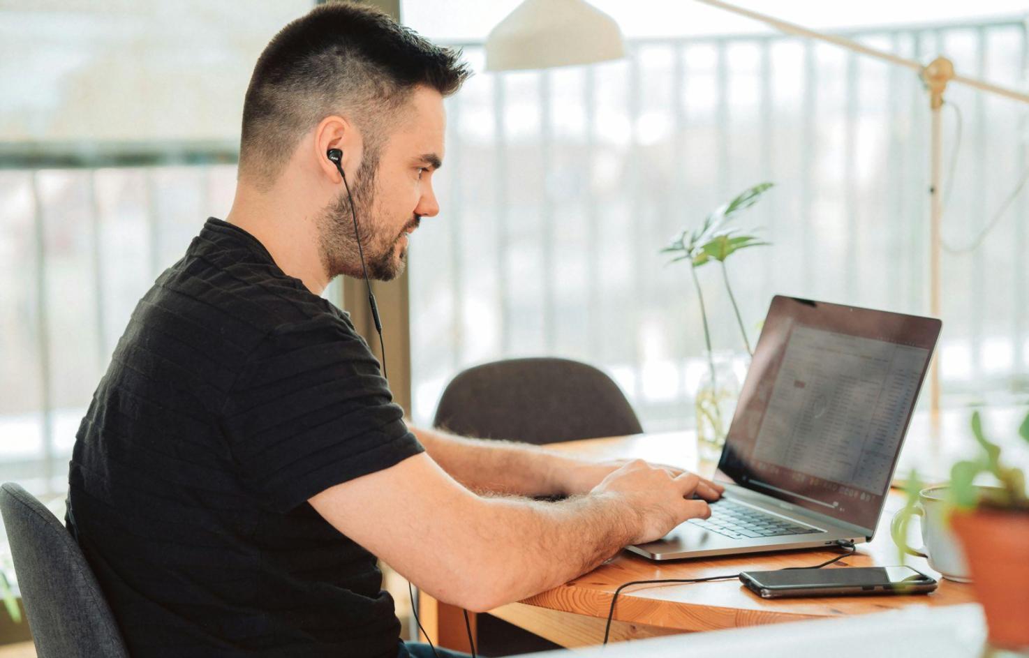 Multiple UI design mockups showing mobile app interfaces, web dashboards, and design system components spread across a desk
